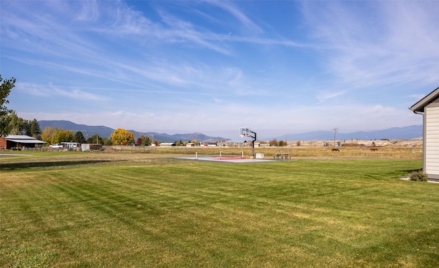 view of yard featuring community basketball court and a mountain view