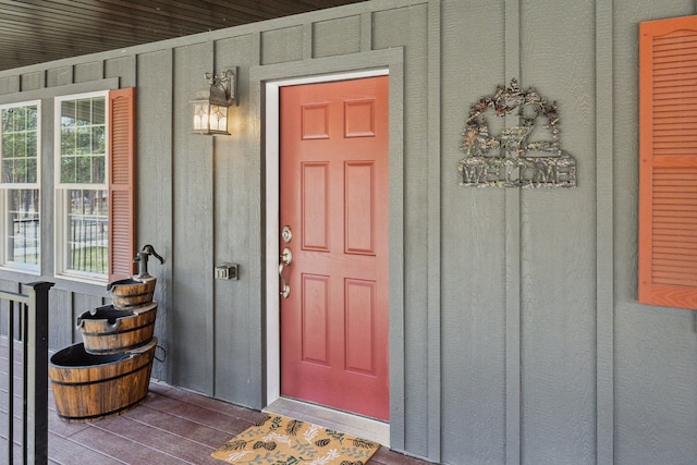 view of exterior entry with board and batten siding