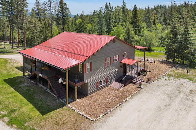 1743 Nighthawk Trl, Victor, MT 59875 - view of home's exterior featuring a wooded view, metal roof, and a yard