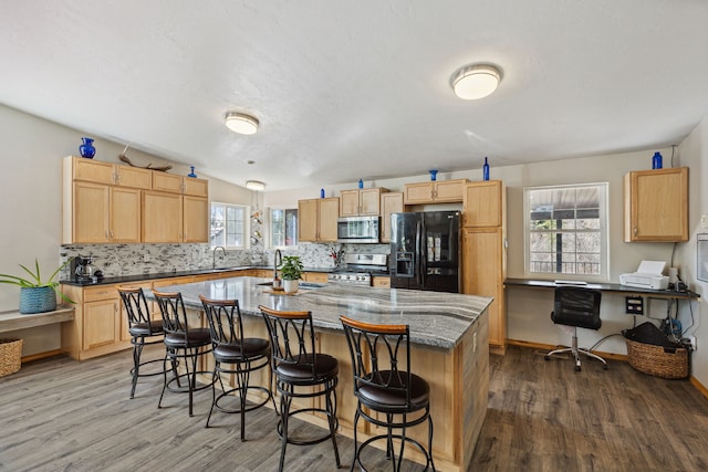1743 Nighthawk Trl, Victor, MT 59875 - kitchen with appliances with stainless steel finishes, wood finished floors, and light brown cabinetry