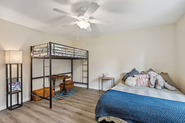 bedroom with wood finished floors and baseboards