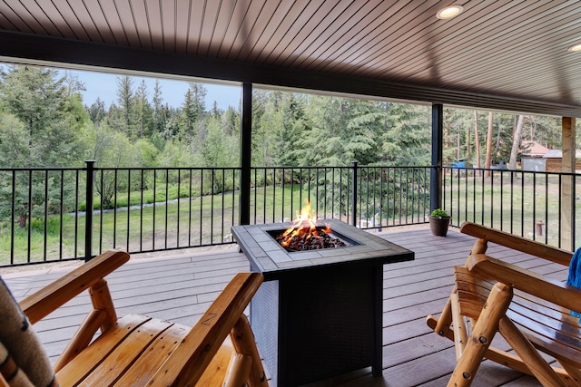 1743 Nighthawk Trl, Victor, MT 59875 - wooden deck with a fire pit and a forest view