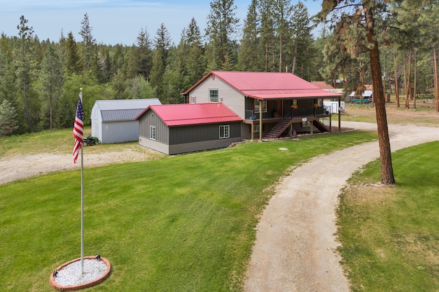 1743 Nighthawk Trl, Victor, MT 59875 - view of front of house featuring driveway, a forest view, stairway, and a front yard