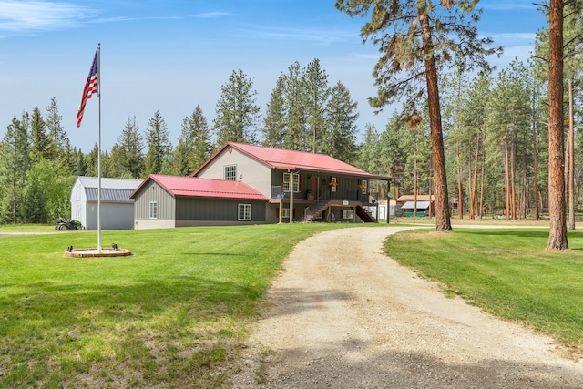 1743 Nighthawk Trl, Victor, MT 59875 - view of front of property with a front lawn, stairs, metal roof, dirt driveway, and covered porch