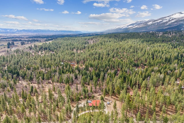 aerial view featuring a forest view and a mountain view