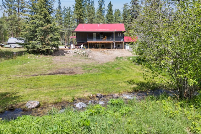 1743 Nighthawk Trl, Victor, MT 59875 - back of property with a deck and metal roof