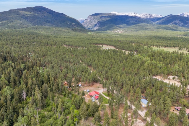 1743 Nighthawk Trl, Victor, MT 59875 - aerial overview of property's location featuring a heavily wooded area and a mountainous background