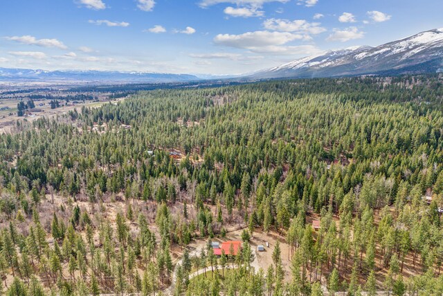 1743 Nighthawk Trl, Victor, MT 59875 - drone / aerial view of a heavily wooded area and a mountain backdrop