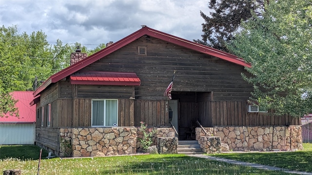 403 Dakota Ave, Libby, MT 59923 - view of front facade with a chimney and stone siding