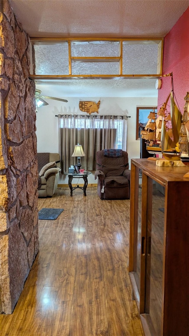403 Dakota Ave, Libby, MT 59923 - corridor with wood finished floors, a textured ceiling, and healthy amount of natural light