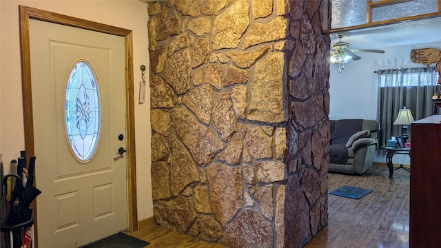 foyer featuring ceiling fan and wood finished floors