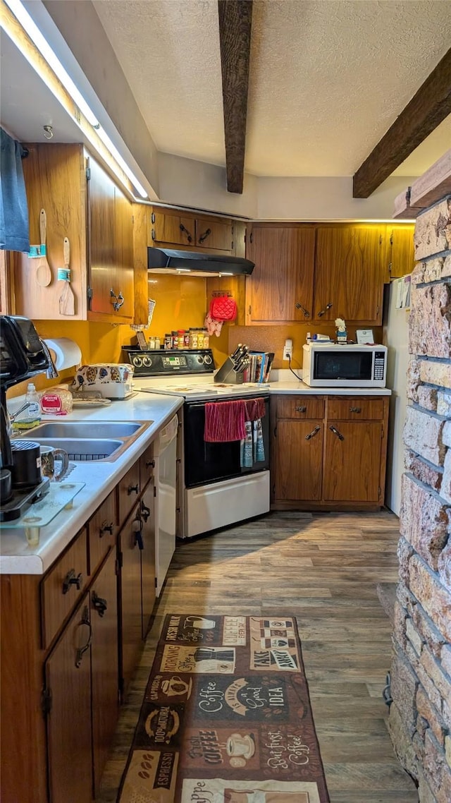 403 Dakota Ave, Libby, MT 59923 - kitchen featuring white microwave, electric range, beamed ceiling, a textured ceiling, and a sink