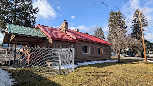 403 Dakota Ave, Libby, MT 59923 - view of home's exterior with a chimney, a gate, and a metal roof