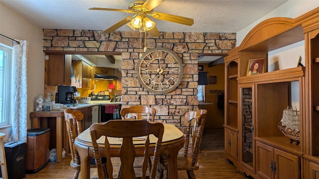 dining room featuring a textured ceiling, a ceiling fan, and light wood-style floors