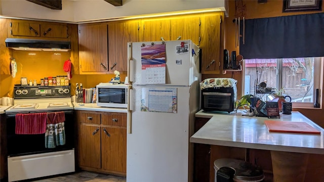 kitchen with light countertops, white appliances, ventilation hood, and brown cabinets