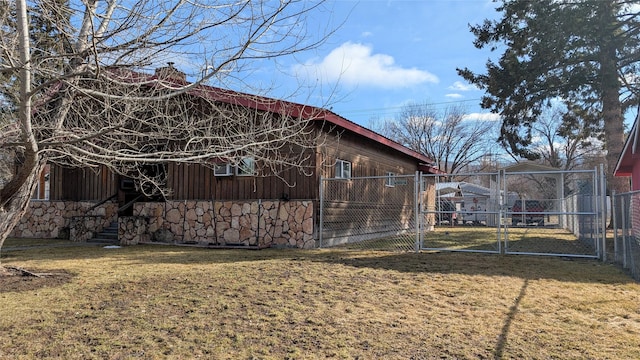 view of property exterior featuring a gate, a chimney, fence, and a yard