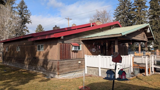 403 Dakota Ave, Libby, MT 59923 - view of home's exterior with a yard, a chimney, and metal roof