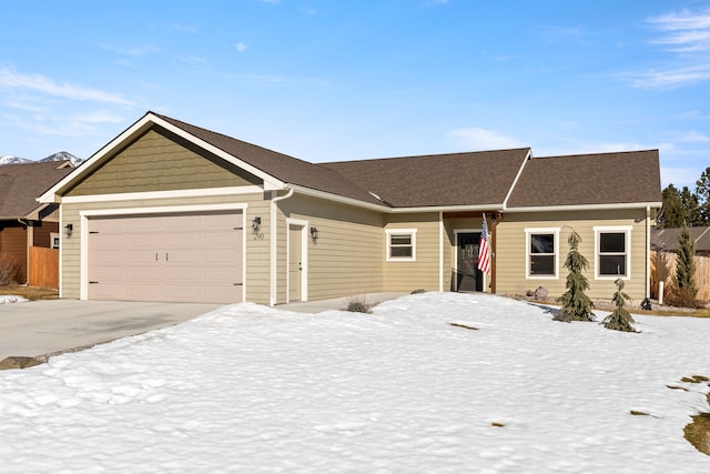 ranch-style house with a garage and driveway