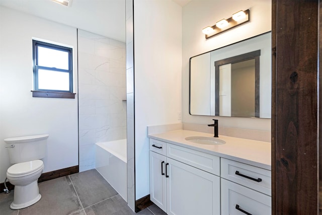 bathroom featuring tile patterned flooring, vanity, toilet, and baseboards