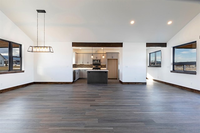 unfurnished living room featuring baseboards, vaulted ceiling, dark wood finished floors, and recessed lighting