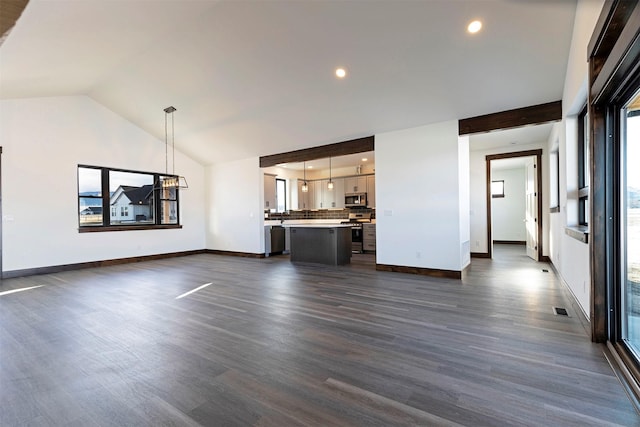 unfurnished living room featuring dark wood-style flooring, visible vents, vaulted ceiling, and baseboards