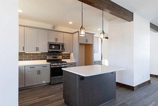 kitchen featuring stainless steel appliances, beamed ceiling, gray cabinets, and decorative backsplash