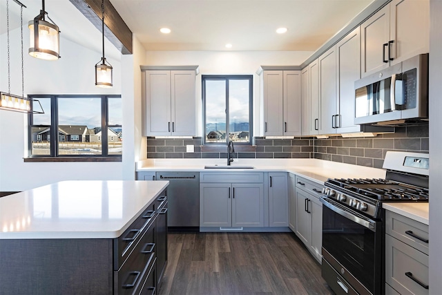 kitchen featuring light countertops, appliances with stainless steel finishes, and a sink