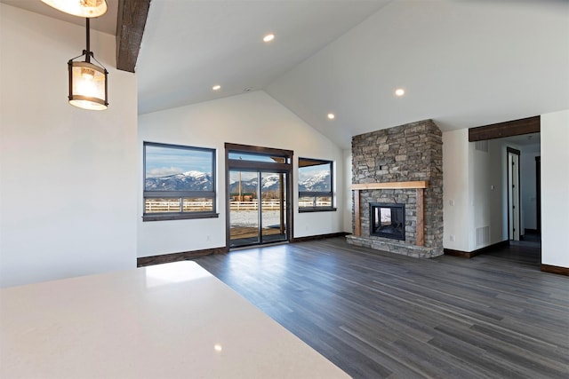 unfurnished living room with high vaulted ceiling, baseboards, dark wood-style flooring, and a stone fireplace