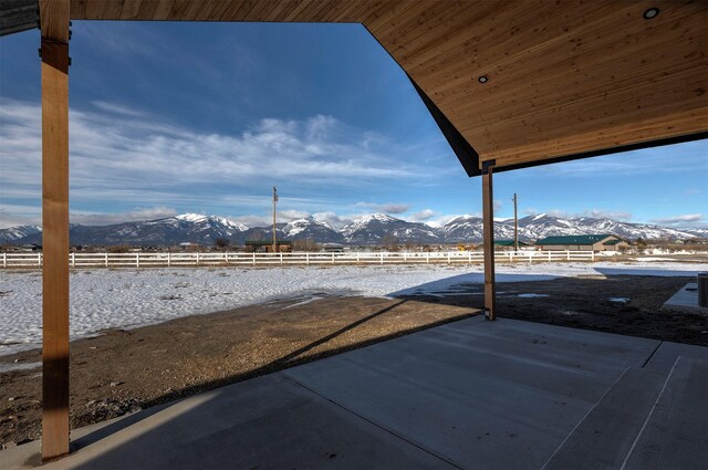 view of patio featuring fence and a mountain view