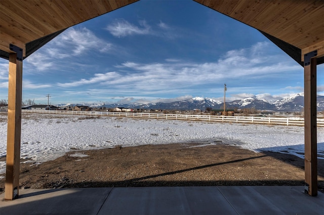 view of yard featuring fence and a mountain view