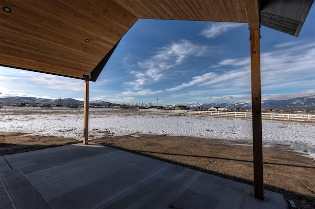 view of yard with a patio area, fence, and a mountain view