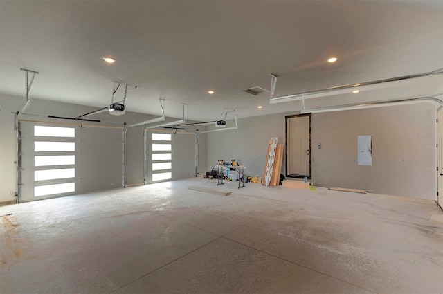 garage with electric panel and a garage door opener