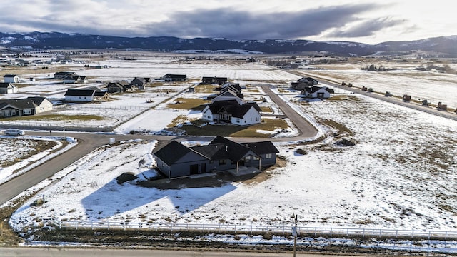 snowy aerial view with a mountain view