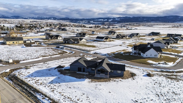 snowy aerial view with a mountain view