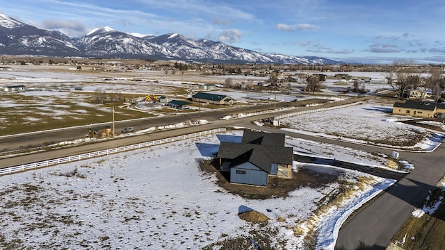 snowy aerial view with a mountain view