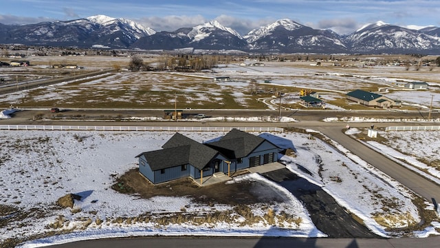 snowy aerial view featuring a mountain view