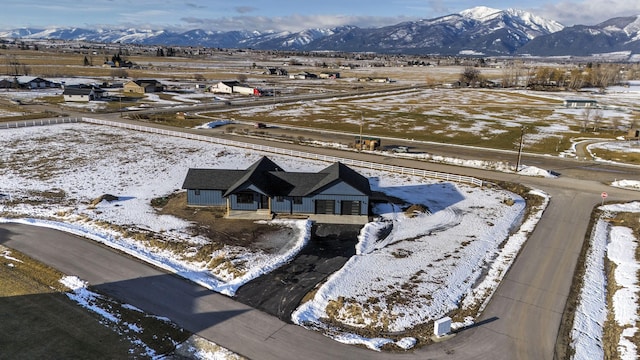 snowy aerial view featuring a mountain view