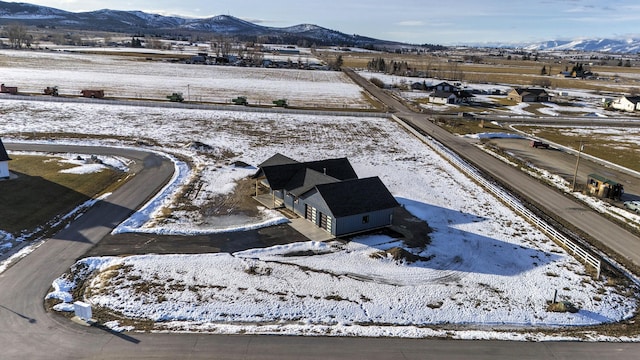 snowy aerial view with a mountain view