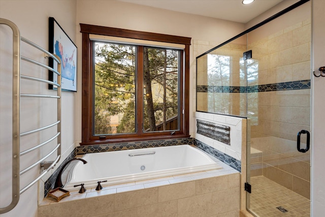 bathroom featuring a stall shower, a bath, and recessed lighting