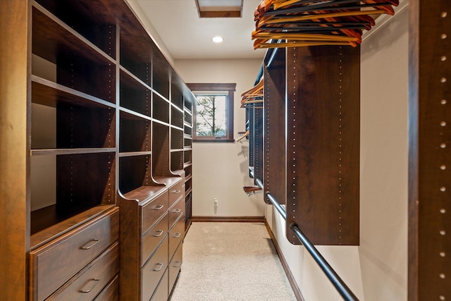 spacious closet featuring light colored carpet