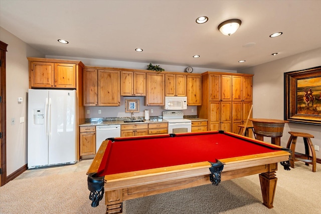 rec room featuring light carpet, baseboards, a sink, and recessed lighting