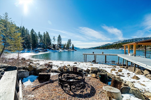 view of dock featuring a fire pit and a water view