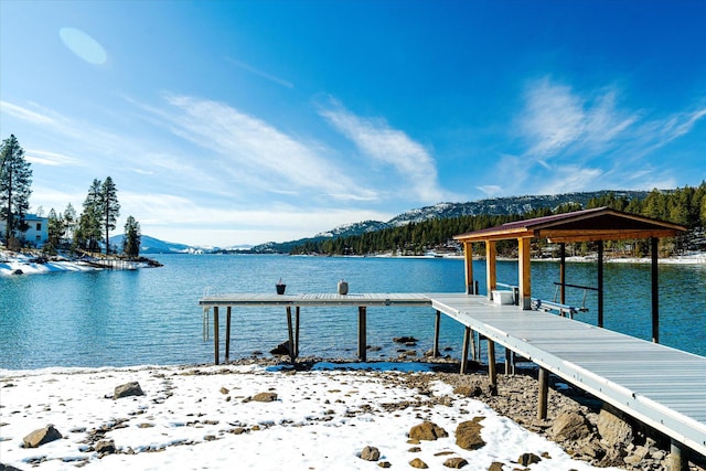 view of dock with a water and mountain view