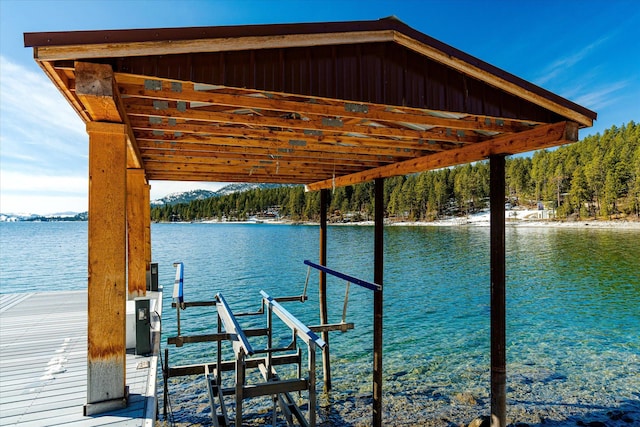 dock area with a water view and boat lift