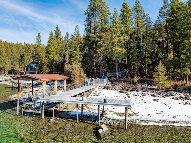 view of dock featuring a view of trees