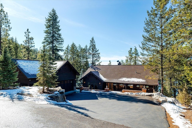 view of front of property featuring a garage and an outdoor structure