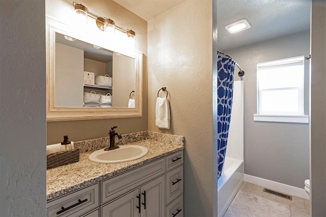 bathroom with toilet, vanity, visible vents, baseboards, and tile patterned floors