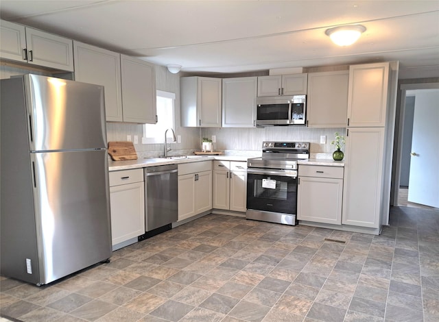 2968 Sunnyside Rd, Helena, MT 59602 - kitchen with stainless steel appliances, a sink, light countertops, and stone finish flooring