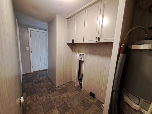 2968 Sunnyside Rd, Helena, MT 59602 - washroom featuring stone finish floors, water heater, and cabinet space