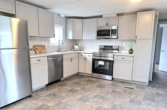 2968 Sunnyside Rd, Helena, MT 59602 - kitchen with appliances with stainless steel finishes, a sink, light countertops, and stone finish flooring
